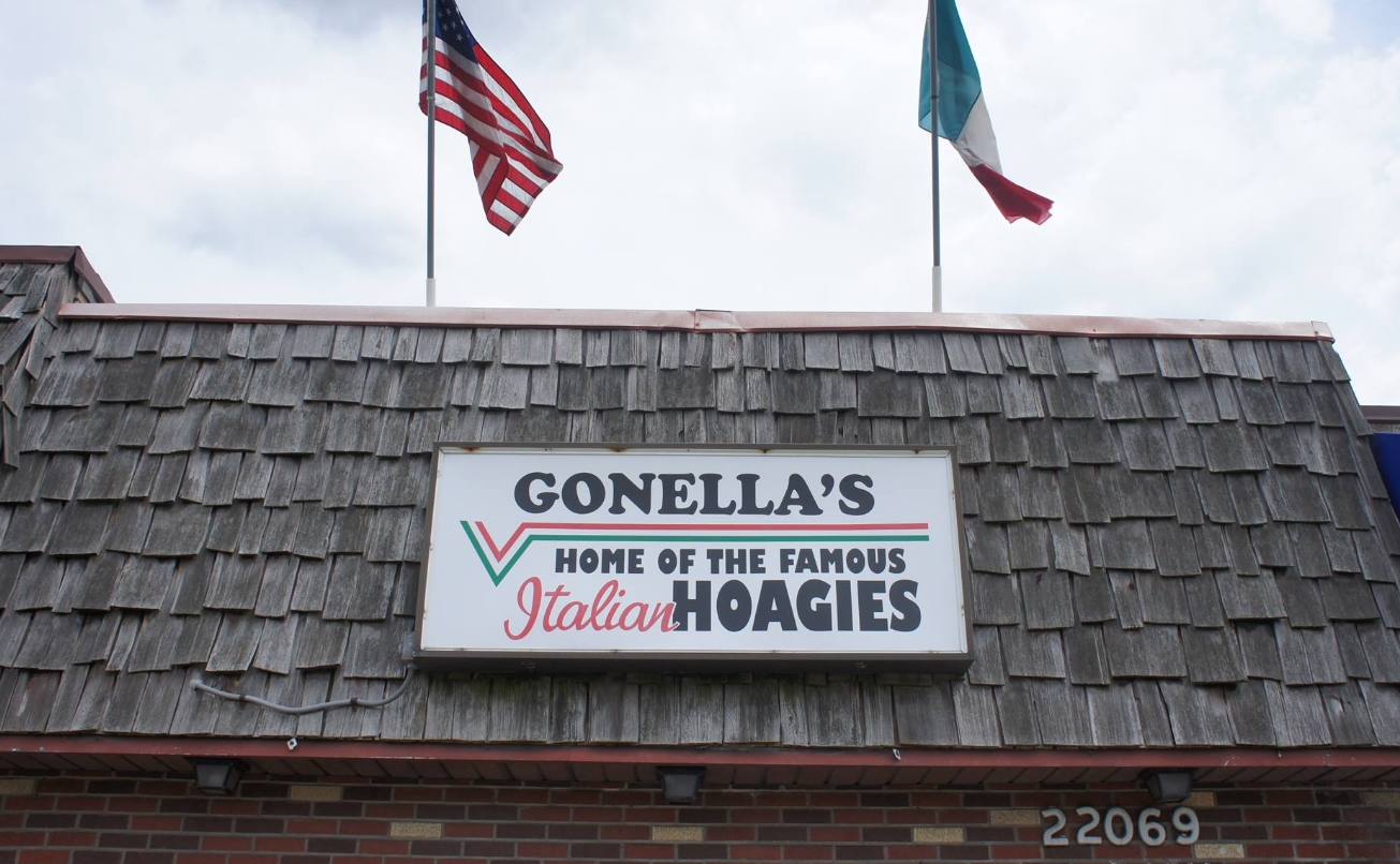 Gonella's storefront sign with American and Italian flags